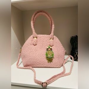 Custom handmade handbag and Matryoshka brooch by the designer.